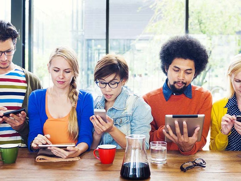 People reading information on their hand held devices