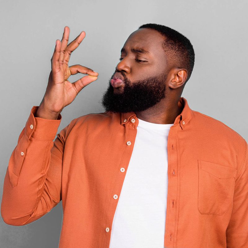 A man kissing his fingers in perfection