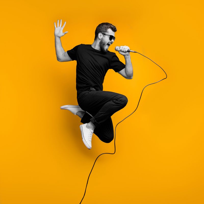 A guy singing into a microphone