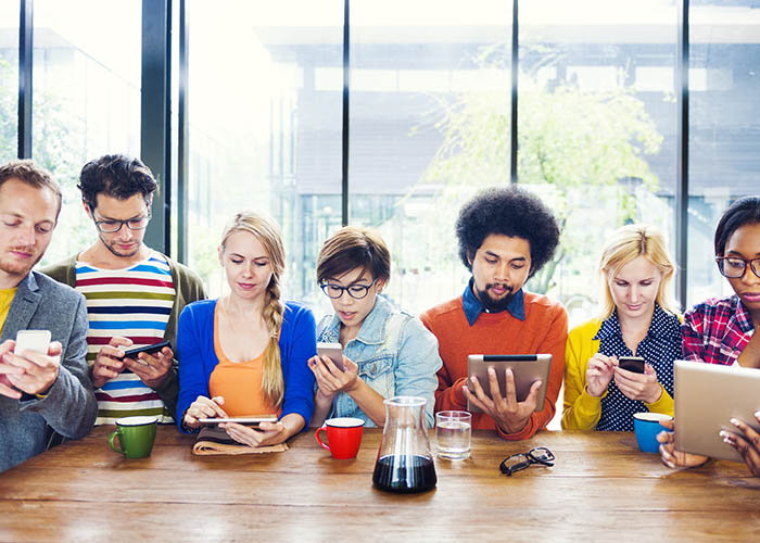 Group of people on their smart phones and tablets