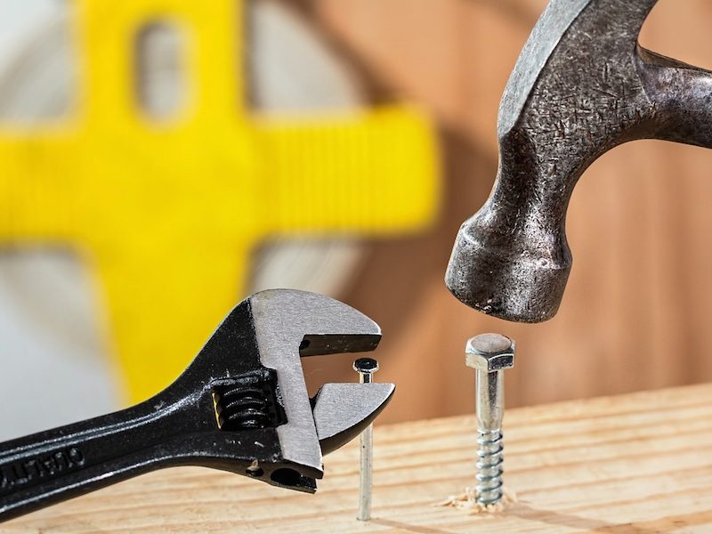 Hammer trying to hammer a screw and a spanner trying to screw a nail