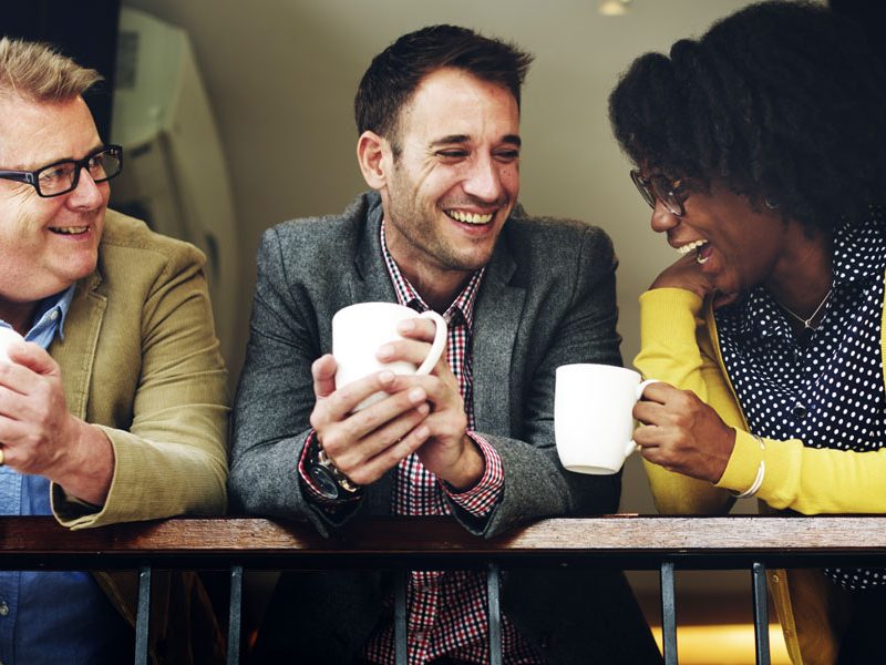 |Two people sitting in a cafe looking at laptop and tablet|Woman in home office on the phone|Four hands doing a group High Five|