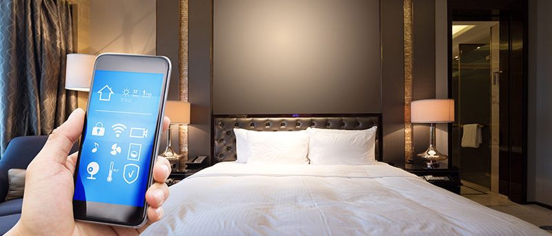 a mobile app in a hotel|a woman on her phone in a hotel|a man being scanned|A group of people planting a tree|a man with robot technology in a hotel lobby|a woman with facial recognition software|A man with facial recognition software|online hotel booking||technology in a hotel room