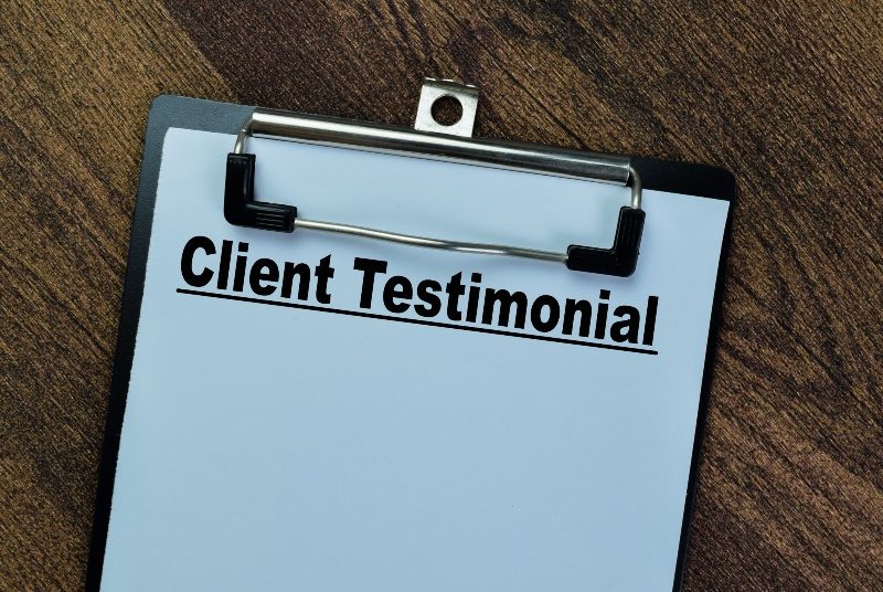client testimonials written on paper on a clipboard