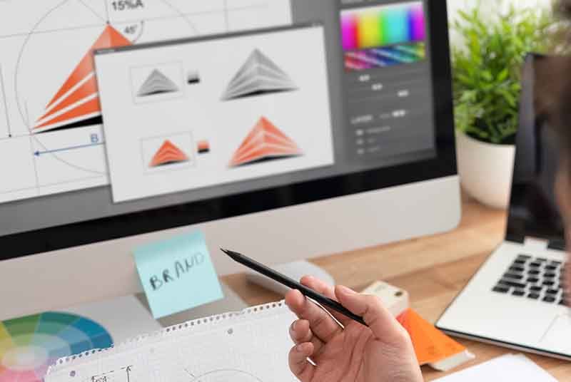 A man designing graphics on a computer.