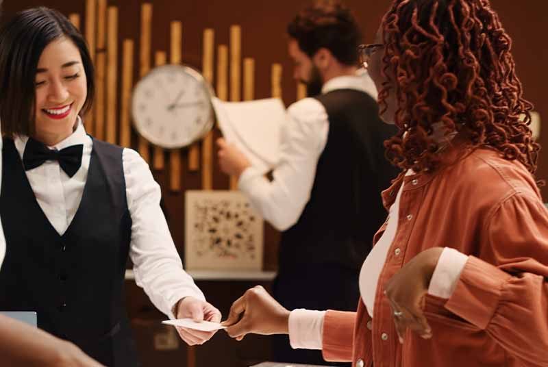 Tourists checking into a hotel reception