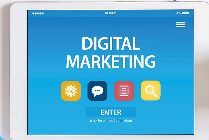 A computer screen with the words "DIGITAL MARKETING" above social media icons.
